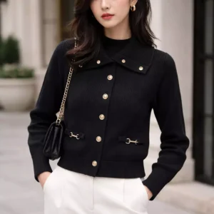 black cardigan is a stylish and comfortable piece featuring gold buttons and hardware