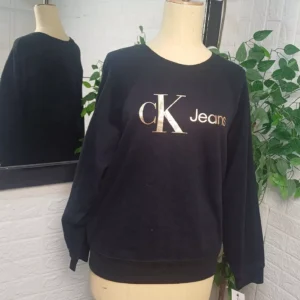 a black Calvin Klein Jeans crewneck sweatshirt featuring a gold metallic logo