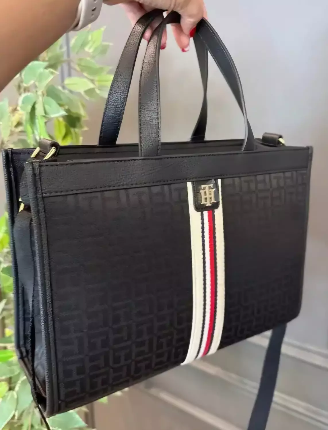 Tommy Hilfiger the bag features an all-over TH monogram print on a dark fabric