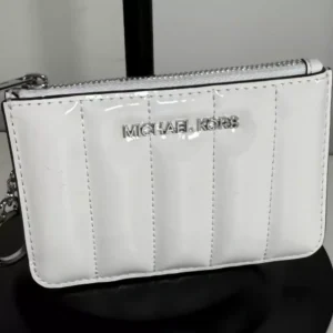 Michael Kors coin purse shown is the Jet Set Small Patent