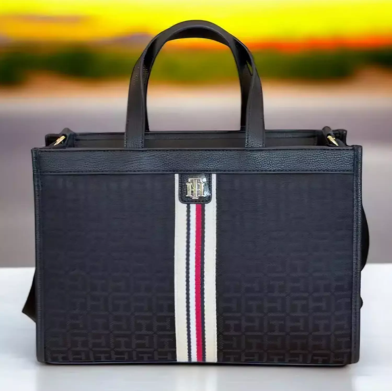 Tommy Hilfiger the bag features an all-over TH monogram print on a dark fabric - Image 2