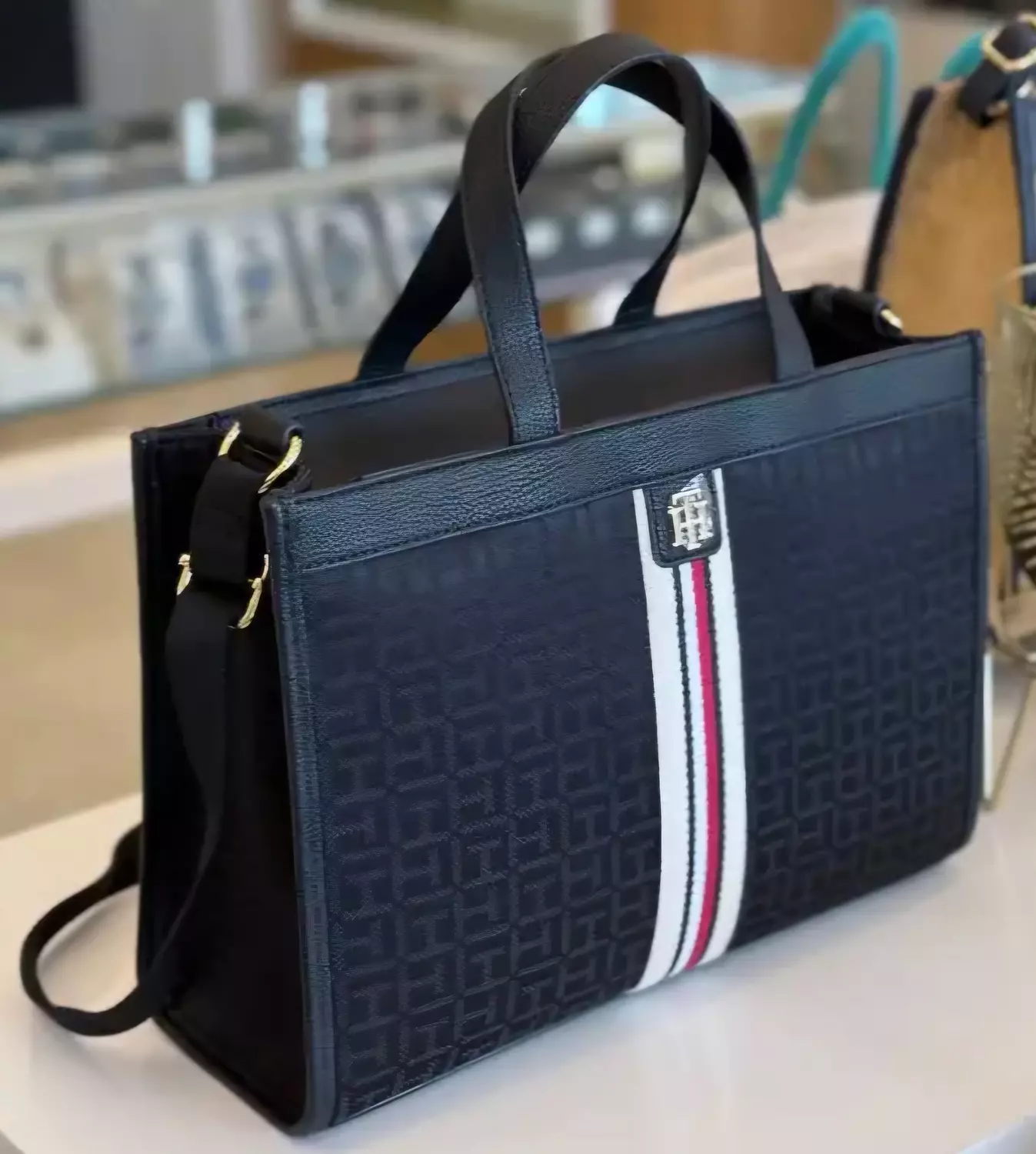 Tommy Hilfiger the bag features an all-over TH monogram print on a dark fabric - Image 3